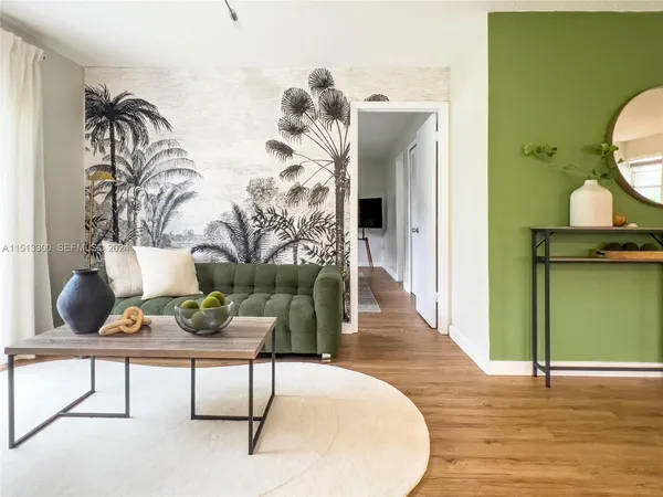 a living room with furniture and wooden floor