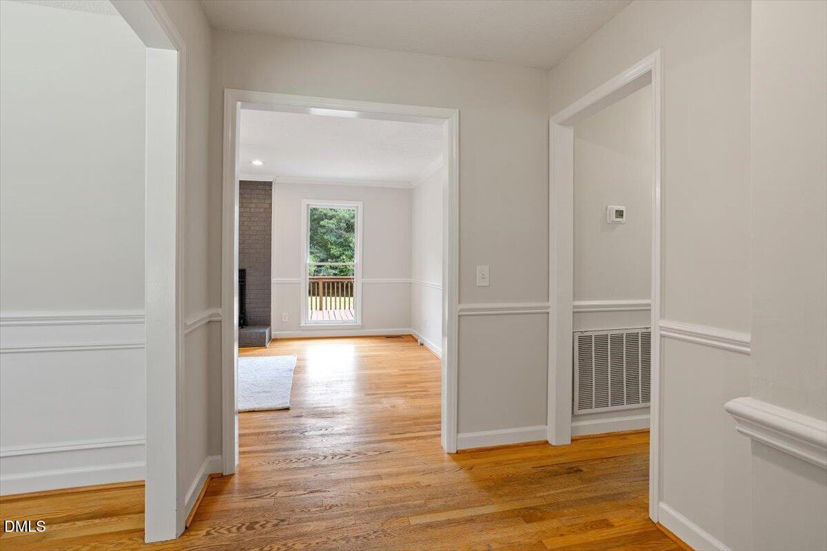 805 Rand Road Garner, NC 27529 - Photo 14 of 38 a view of an empty room with wooden floor and a window