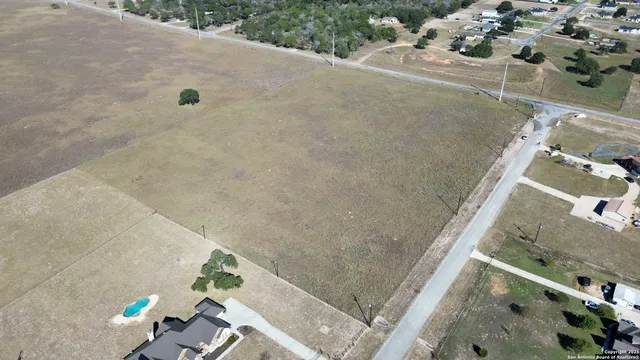 an aerial view of a house with a yard