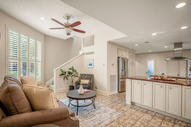a living room with furniture and a potted plant