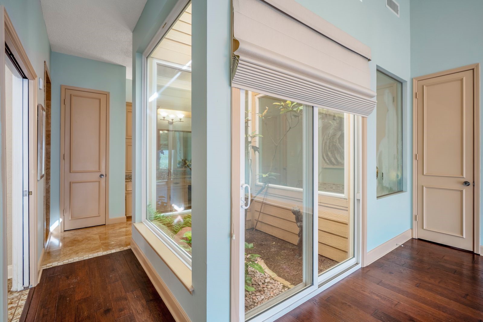 1306 Riverview Court Houston, TX 77077 - Photo 28 of 44 a view of a hallway with wooden floor and windows