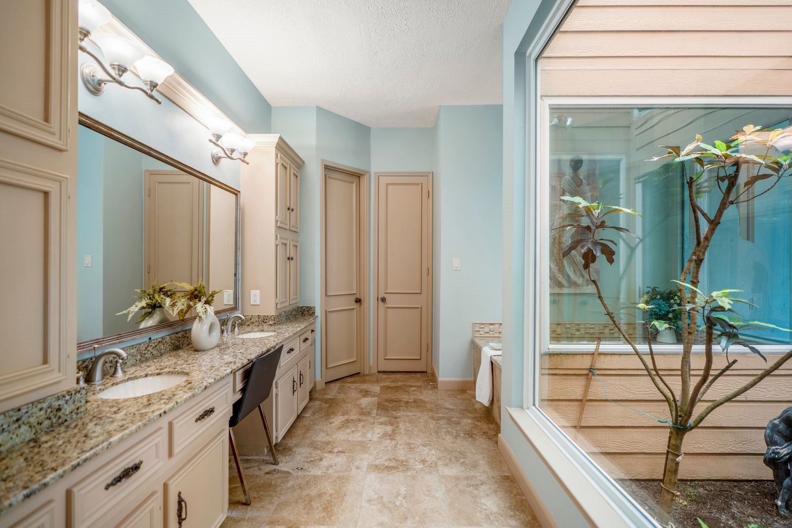 1306 Riverview Court Houston, TX 77077 - Photo 29 of 44 a spacious bathroom with a granite countertop sink a mirror and shower