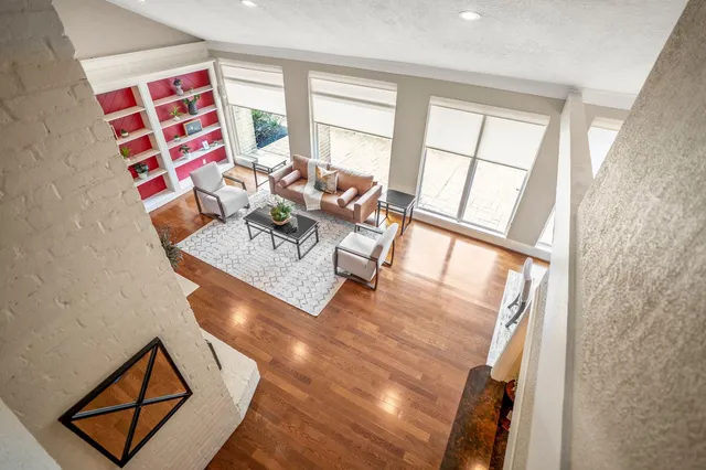 a view of a room with wooden floor and windows