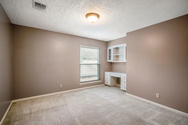 a view of a lounge chairs in the back yard of the house