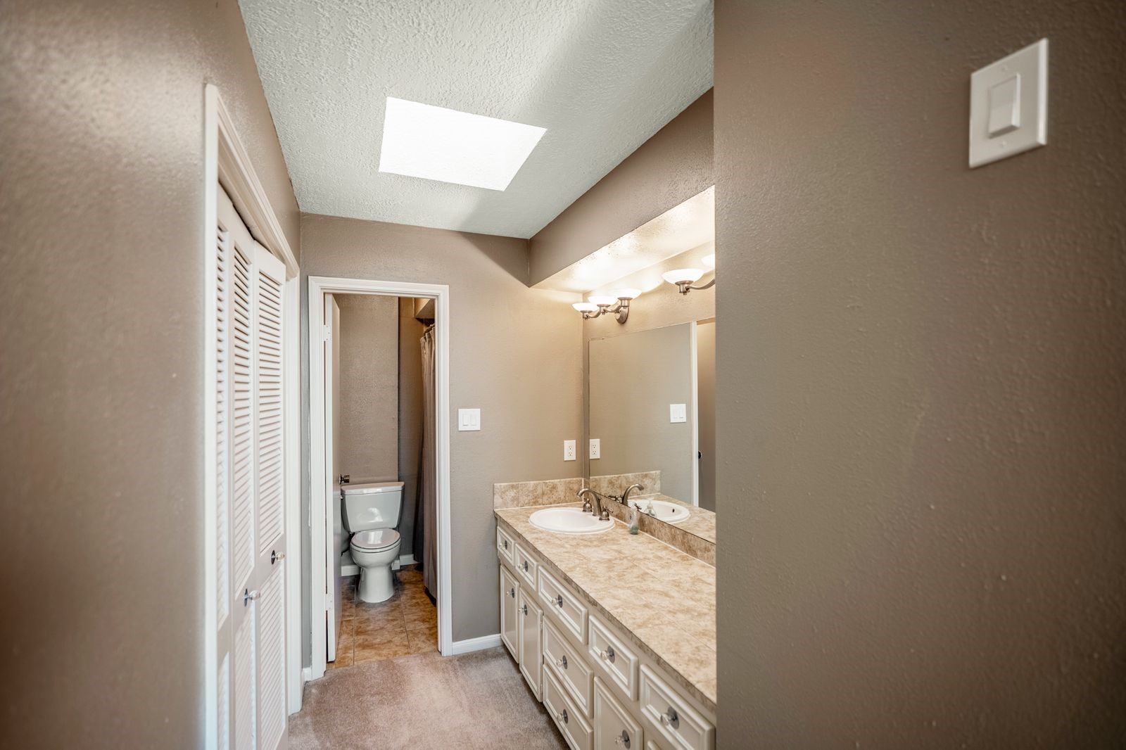 1306 Riverview Court Houston, TX 77077 - Photo 37 of 44 a bathroom with a double vanity sink and mirror