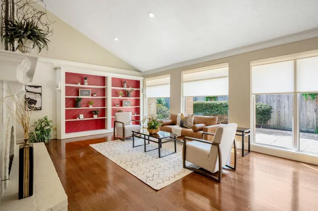 a living room with furniture and a floor to ceiling window