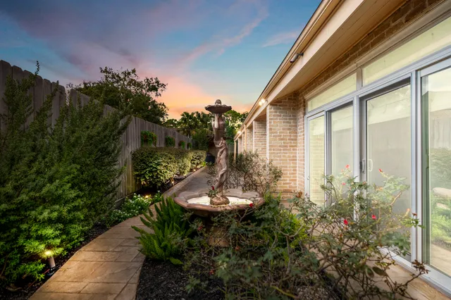 a backyard of a house with outdoor seating and green space