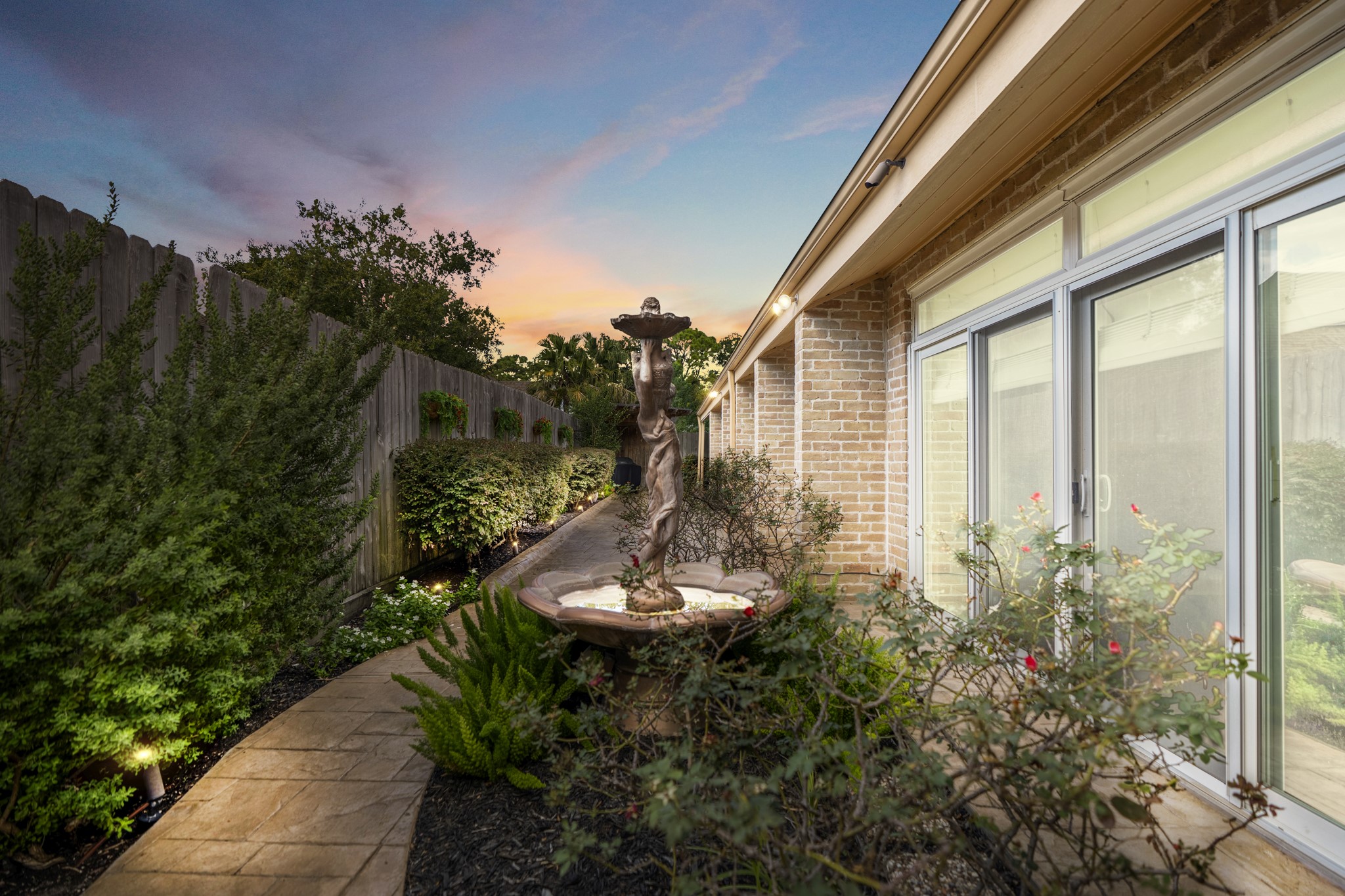 1306 Riverview Court Houston, TX 77077 - Photo 7 of 44 a backyard of a house with outdoor seating and green space