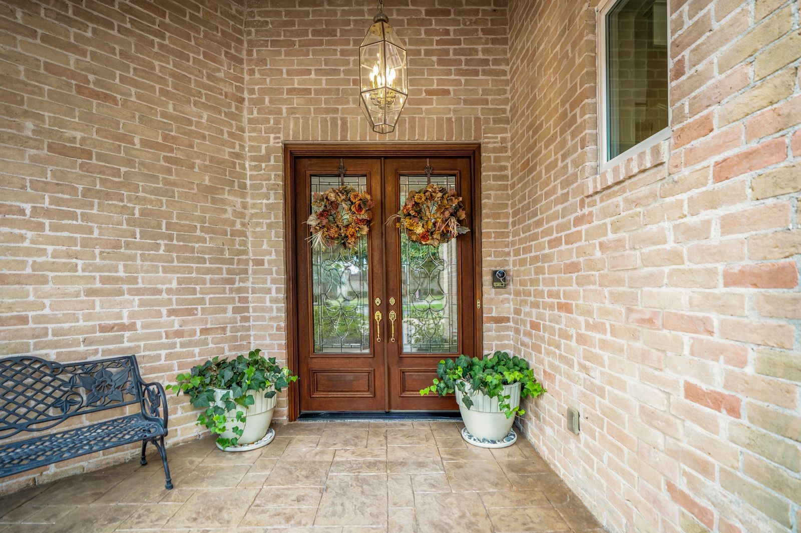 1306 Riverview Court Houston, TX 77077 - Photo 9 of 44 Enter through the elegant double doors from the charming entryway. The home is equipped with exterior security cameras (staying), providing both safety and peace of mind.