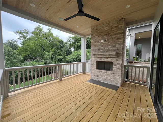 a view of balcony with wooden floor and fence