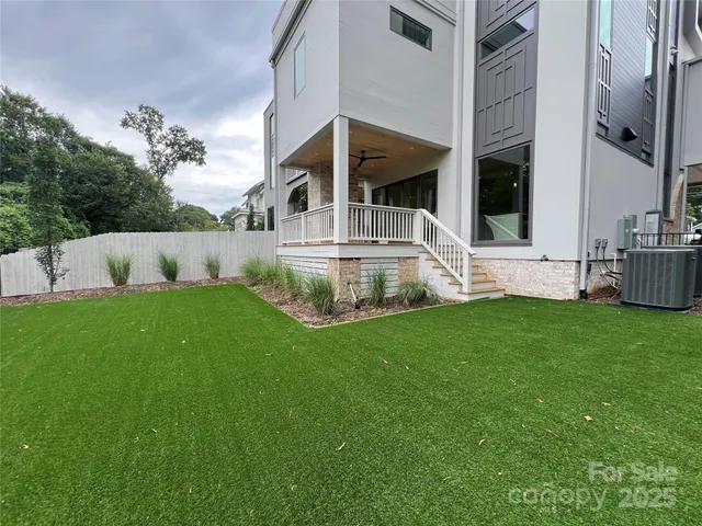 a view of house with backyard outdoor seating and green space