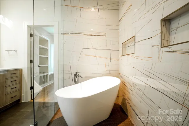 a bathroom with a bathtub and shower