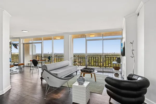 a living room with furniture and a large window