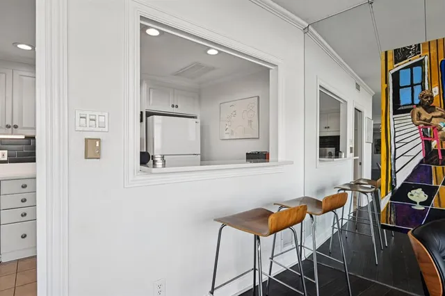 a view of a dining room with furniture and a mirror