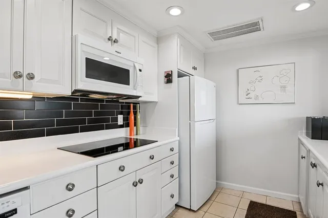 a kitchen with stainless steel appliances a refrigerator sink and microwave