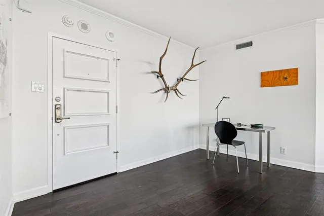 a view of a livingroom with wooden floor closet and windows
