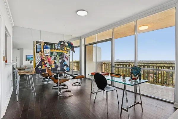 a view of a livingroom with furniture and floor to ceiling window
