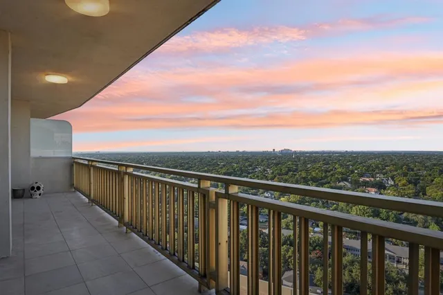 a balcony with view of city and mountain