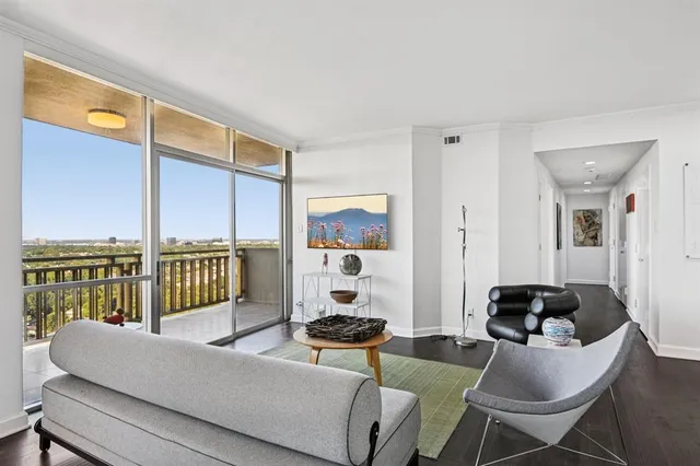 a living room with furniture and a floor to ceiling window