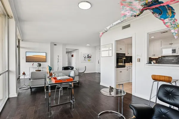a living room with furniture and a dining table with kitchen view