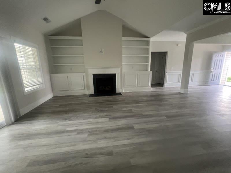 516 Mitscher Way Chapin, SC 29036 - Photo 5 of 18 a view of empty room with wooden floor and fireplace