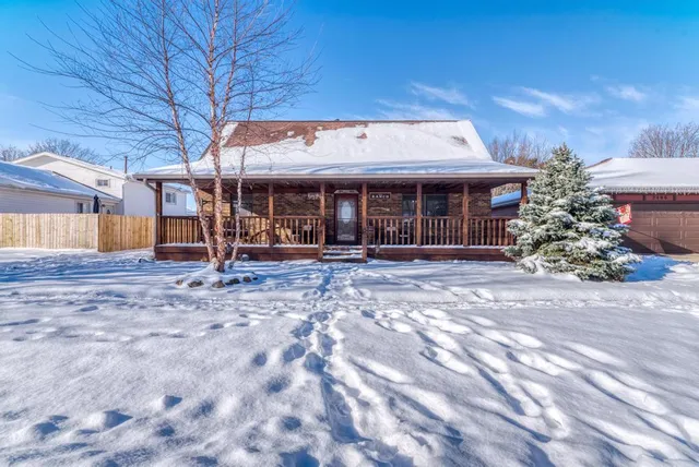 a backyard of a house with barbeque oven table and chairs