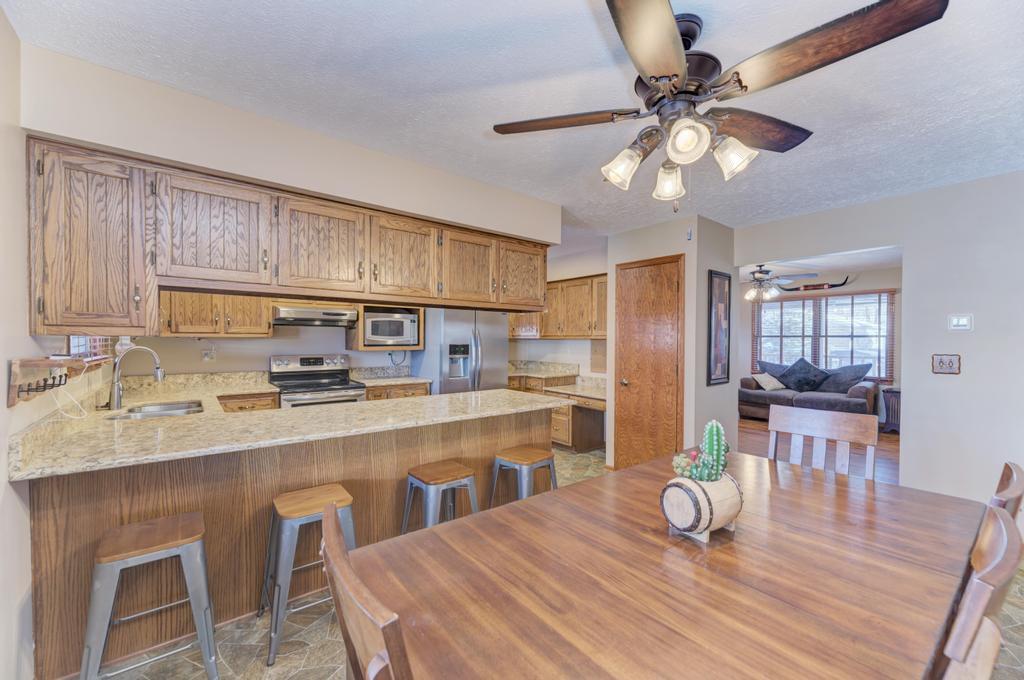 2402 Chestnut Lane Morris, IL 60450 - Photo 11 of 30 a kitchen with stainless steel appliances wooden floor dining table and chairs