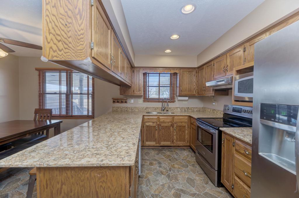 2402 Chestnut Lane Morris, IL 60450 - Photo 12 of 30 a kitchen with stainless steel appliances granite countertop a stove a sink and a microwave