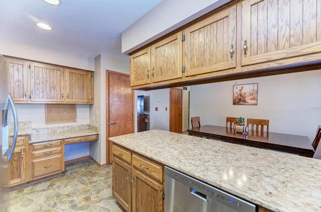 a kitchen with stainless steel appliances granite countertop a sink stove and cabinets