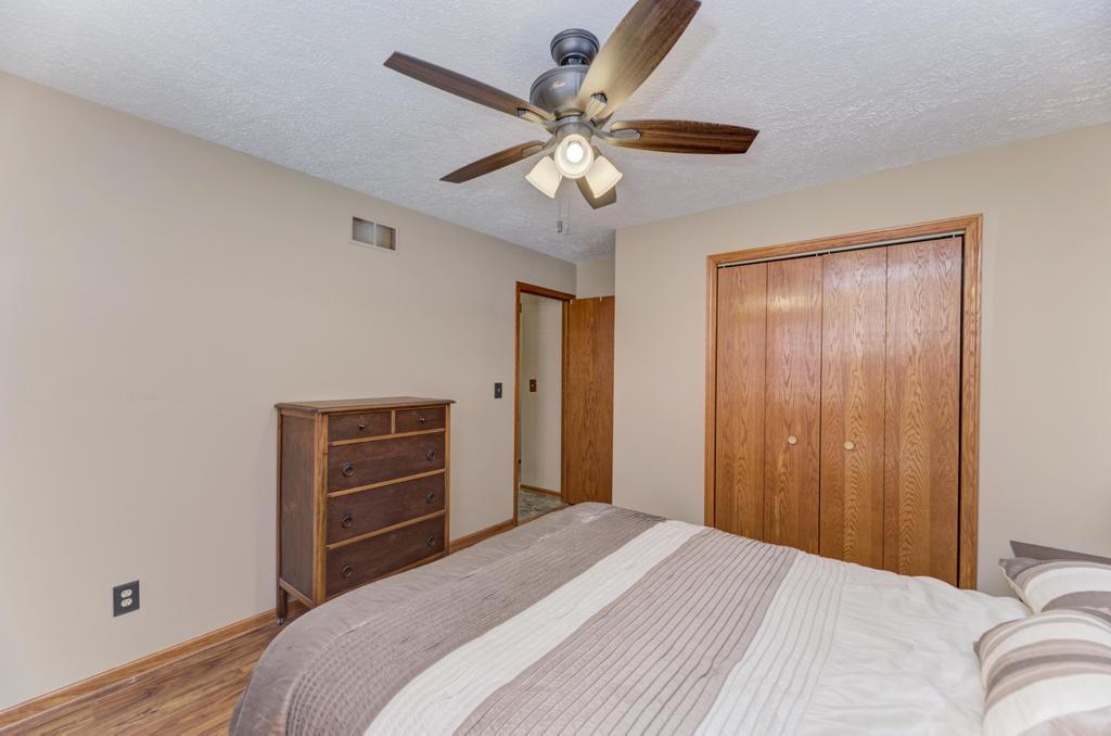 2402 Chestnut Lane Morris, IL 60450 - Photo 16 of 30 a bedroom with a bed and a chandelier