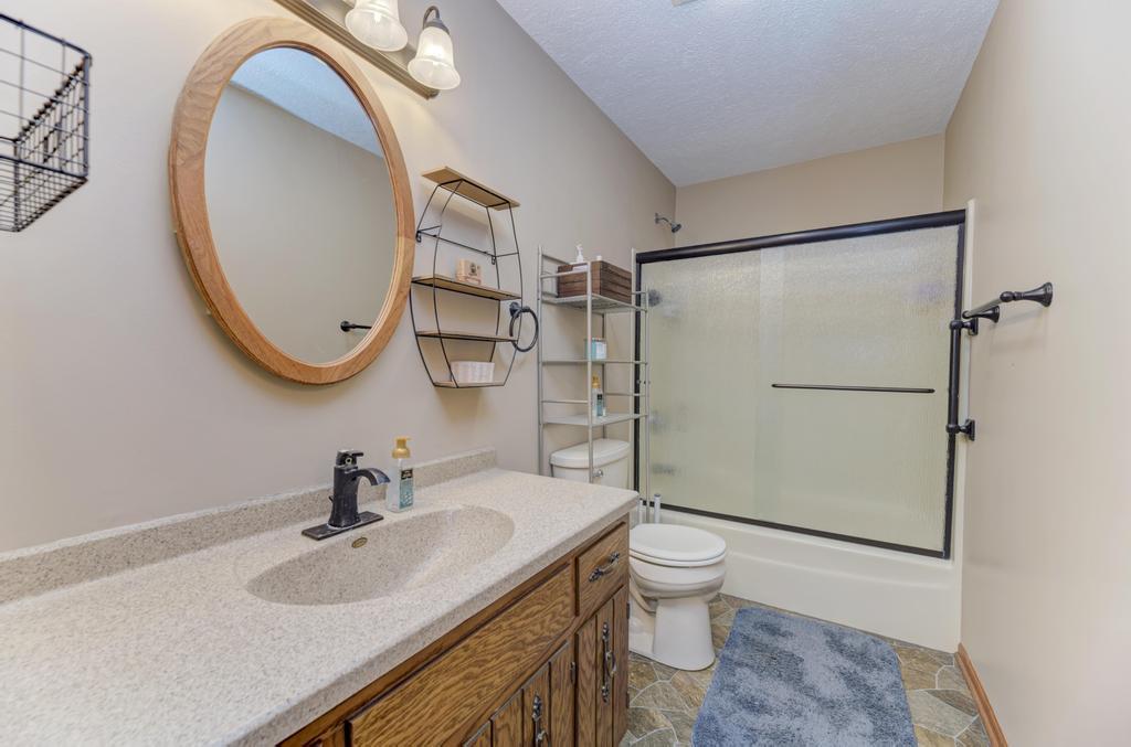 2402 Chestnut Lane Morris, IL 60450 - Photo 17 of 30 a bathroom with a sink a toilet and a mirror