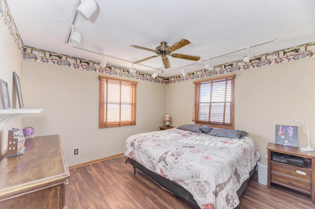 2402 Chestnut Lane Morris, IL 60450 - Photo 19 of 30 a bedroom with a bed and a chandelier