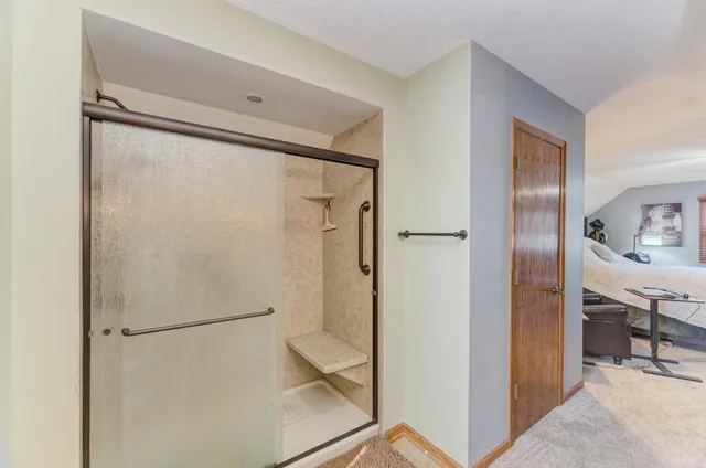 a bathroom with a glass shower door and a sink