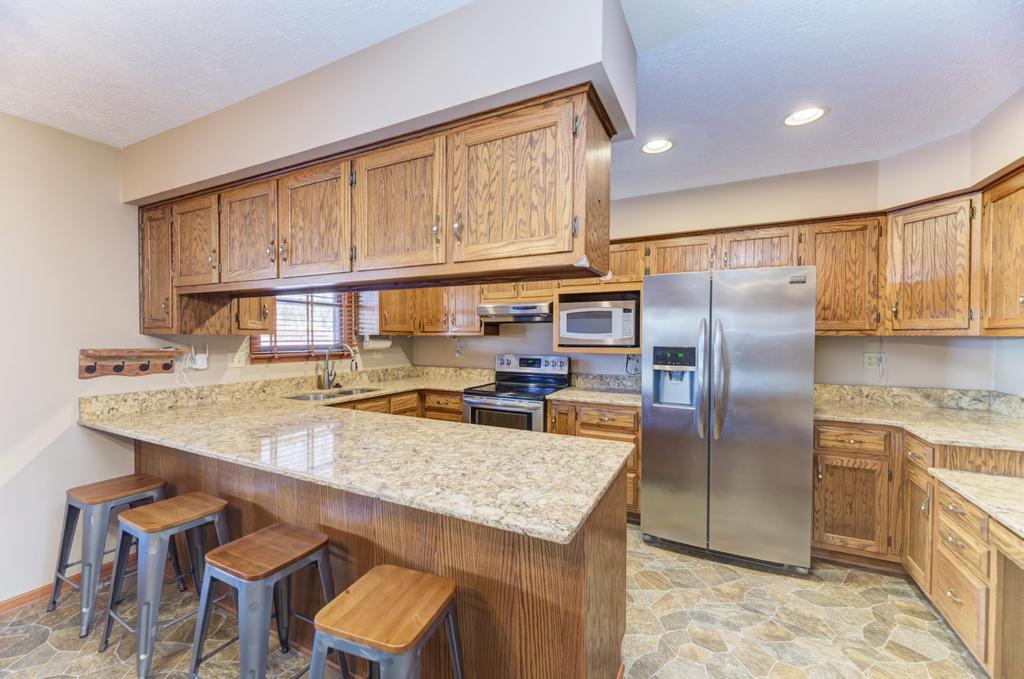 2402 Chestnut Lane Morris, IL 60450 - Photo 9 of 30 a kitchen with stainless steel appliances granite countertop a refrigerator a stove and a sink