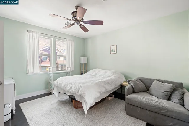 a bedroom with a bed a couch and a window