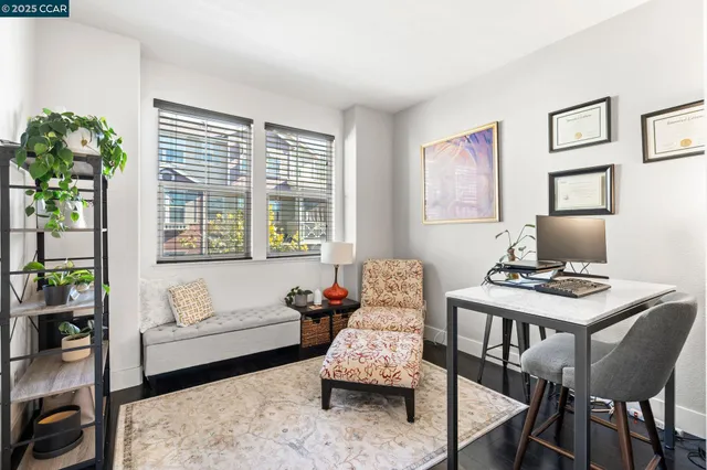 a workspace with furniture and a large window