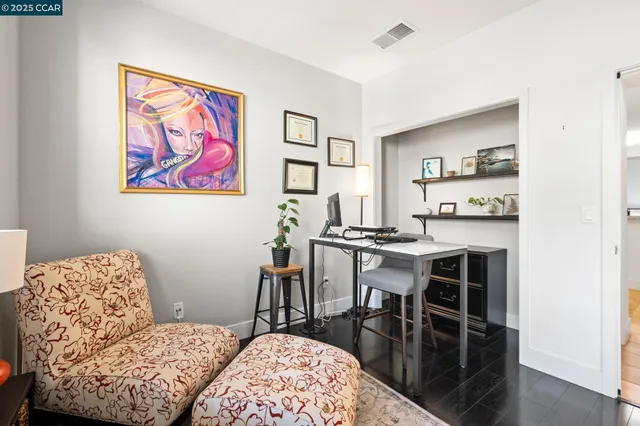 a living room with furniture and a dining table