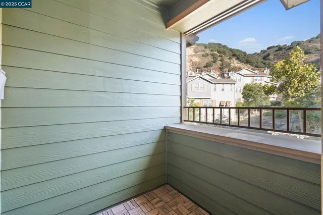 a view of a balcony with wooden floor and fence