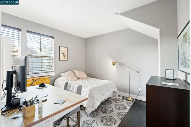 a bed room with two bed and a window