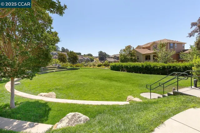 a view of backyard with swimming pool and outdoor seating