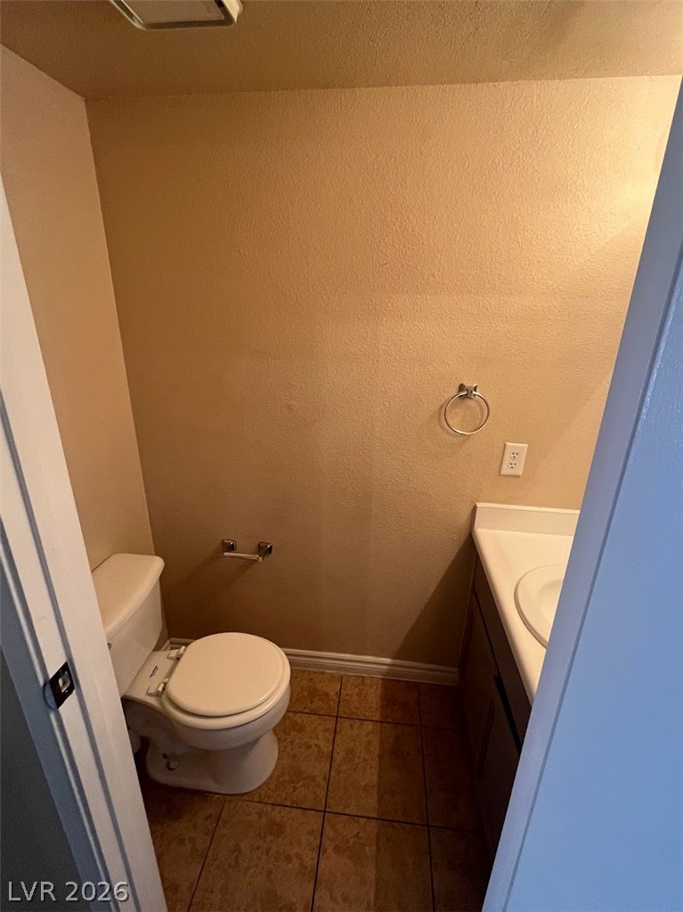914 Scarlet Ridge Drive Las Vegas, NV 89128 - Photo 12 of 25 A compact powder room with practical tile flooring and essential fixtures awaits.