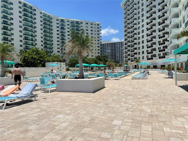a view of swimming pool with outdoor seating and buildings view