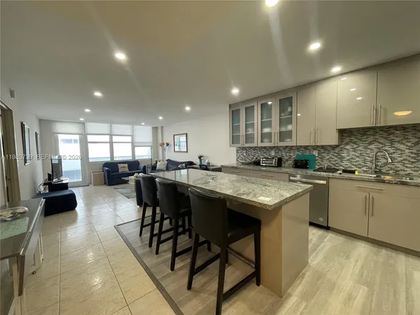a kitchen with lots of counter top space and furniture