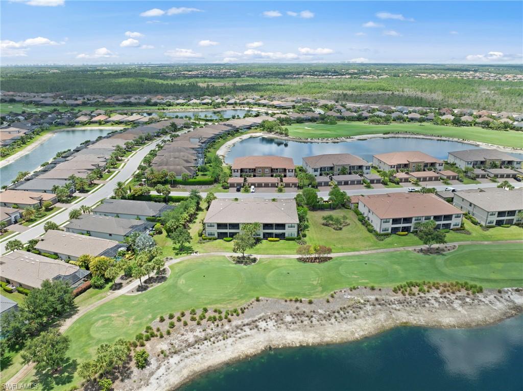 9366 Pocida Court, Unit 202 Naples, FL 34119 - Photo 28 of 44 an aerial view of a houses with outdoor space lake view and mountain view in back