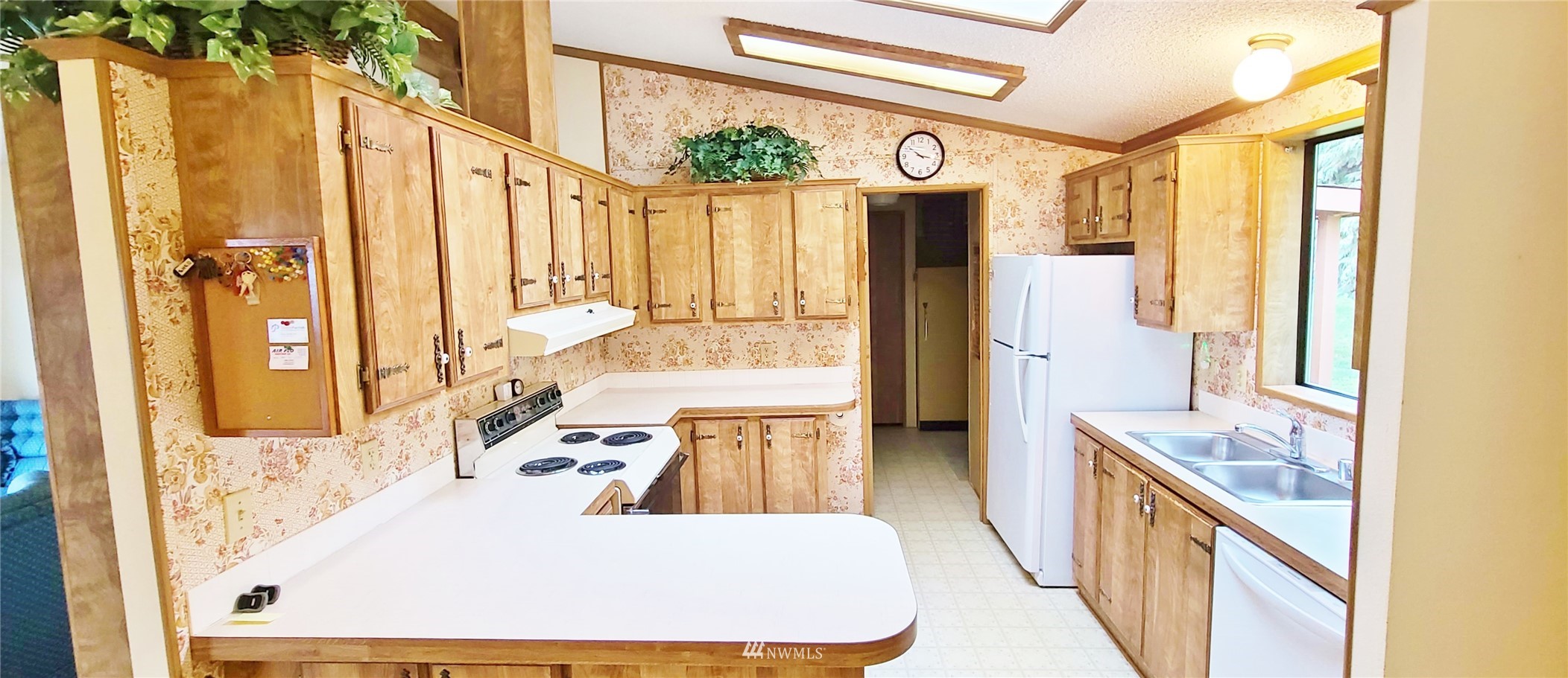 410 Discovery Way Sequim, WA 98382 - Photo 13 of 34 a large white kitchen with a large window