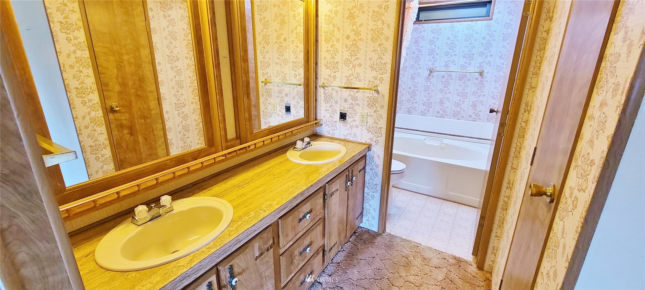 410 Discovery Way Sequim, WA 98382 - Photo 16 of 34 a bathroom with a granite countertop sink and a mirror