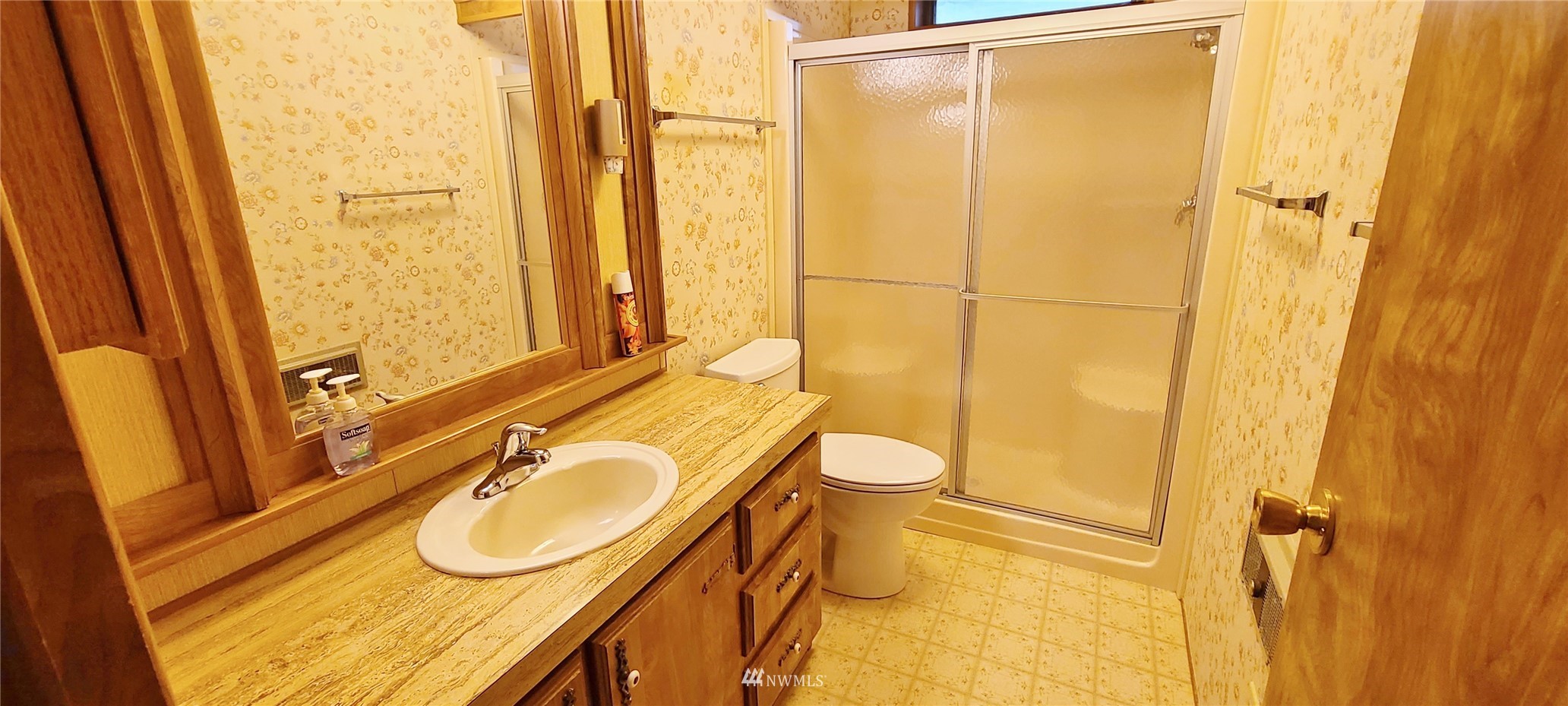 410 Discovery Way Sequim, WA 98382 - Photo 18 of 34 a bathroom with a sink and a mirror