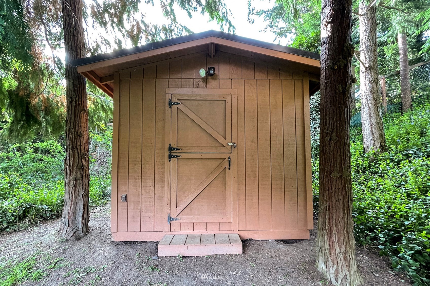 410 Discovery Way Sequim, WA 98382 - Photo 20 of 34 a view of wooden house with a small yard and large trees
