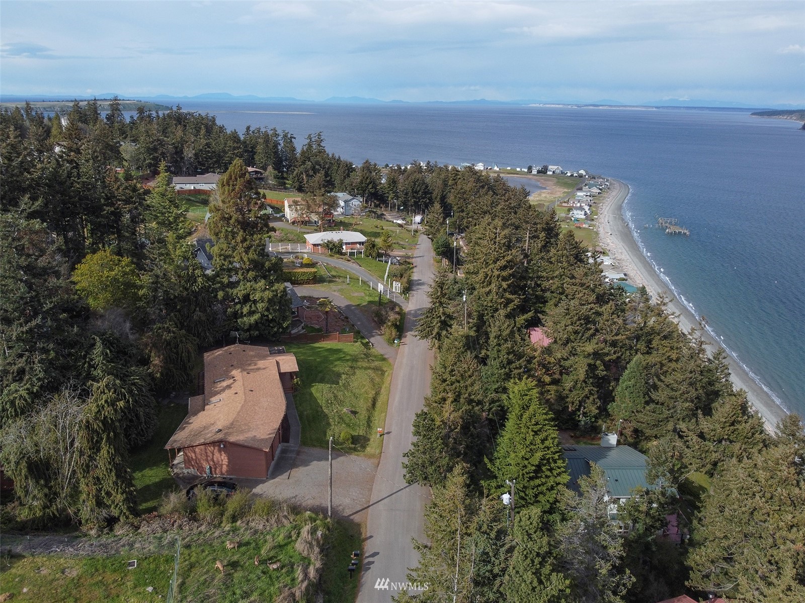 410 Discovery Way Sequim, WA 98382 - Photo 2 of 34 an aerial view of a house with a yard and lake view