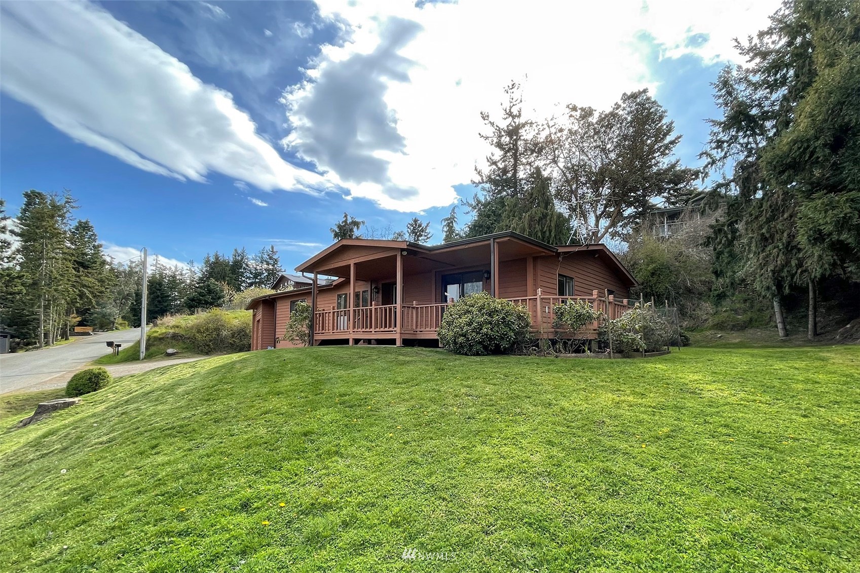 410 Discovery Way Sequim, WA 98382 - Photo 4 of 34 a front view of house with yard and trees in the background